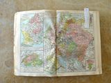an open book with a map on it on a table