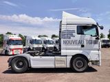 a truck that is parked in a lot with other trucks in the background