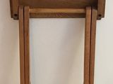 a small wooden table with a drawer on top of it
