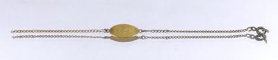 silver bracelet with a yellow stone on a chain on a white background