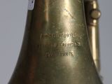 a brass bell with a tag on it on a table