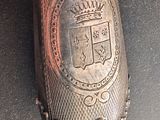 a silver object with a crown on it