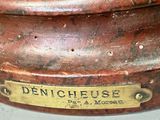 a close up of a metal object with a name plate on it