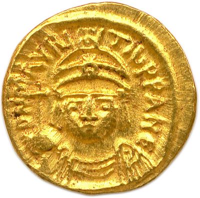 a close up of a gold coin with an image of a man on it