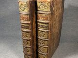 a pair of old books sitting on top of each other