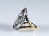 a close up of a silver and gold ring on a white surface