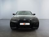 the front of a black bmw car in a white room