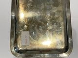 silver plated tray with handle and handles on a white surface