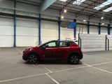 a red car parked in a parking lot in a building