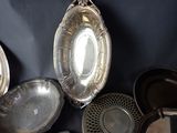 many silver pans and pans on a black table