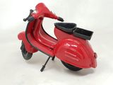 a toy scooter that is sitting on a white surface