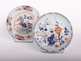pair of blue and orange plates with flowers and birds on them