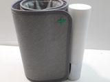 a cup and a cell phone holder on a table