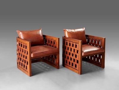 two wooden chairs with leather cushions and a brown leather cushion