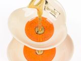 two plates with oranges on them on a white surface