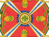 an image of a red and green table cloth with gold and blue decorations