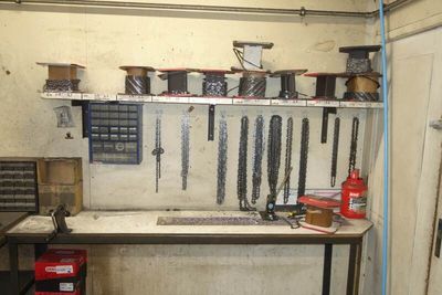 a picture of a workbench in a garage with tools hanging on the wall