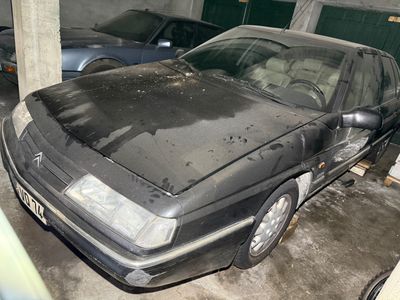 a car that is parked in a garage next to other cars