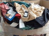 a large cardboard box full of clothes in a warehouse