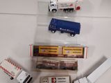 several toy trucks are lined up on a white surface