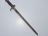 an old sword with a wooden handle on a white surface