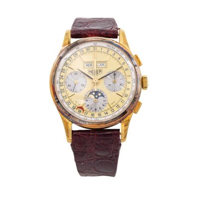 a close up of a watch on a white background with a brown strap