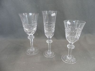 three wine glasses sitting next to each other on a table