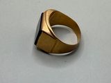 a gold ring with a black stone on it