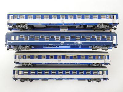 four blue and white train cars stacked on top of each other