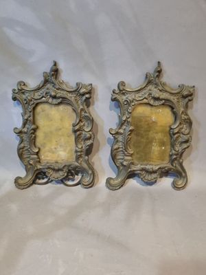 pair of antique silver picture frames on a white background