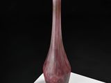 a glass vase that is sitting on a white table