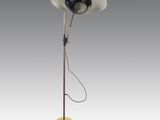 a black and white floor lamp with a yellow base