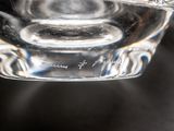 a glass cup with a cigarette in it on a table