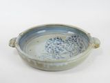a blue and white bowl sitting on a white surface