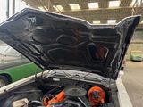 a car that has its hood open in a garage