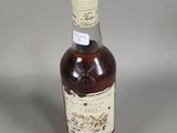 an image of a bottle of liquor sitting on a table
