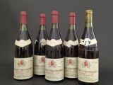 six bottles of wine are lined up in a row on a table