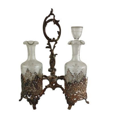 two glass vases on a metal stand with a mirror in the background
