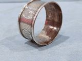 an image of a silver ring sitting on top of a table