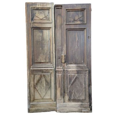 pair of antique wooden doors with glass panels on each side