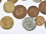 a lot of coins that are on a white surface