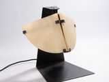 a wooden sculpture of a surfboard on a black stand