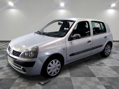 a picture of a small silver car parked in a garage
