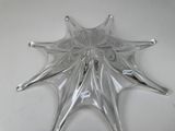a glass star shaped object on a white surface