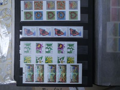 a lot of stamps that are on a black folder