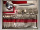 a lot of silverware in a box with a spoon and spoon rest