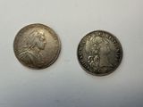 two silver coins, one of which is a woman and one of which is a man