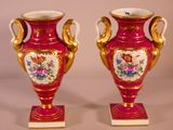 two vases that have been painted with flowers on them