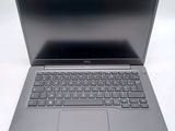 an open laptop computer sitting on top of a white table