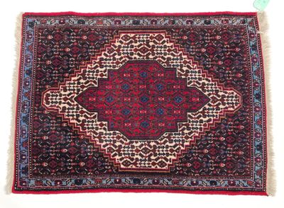 a red rug with a medallion design on it